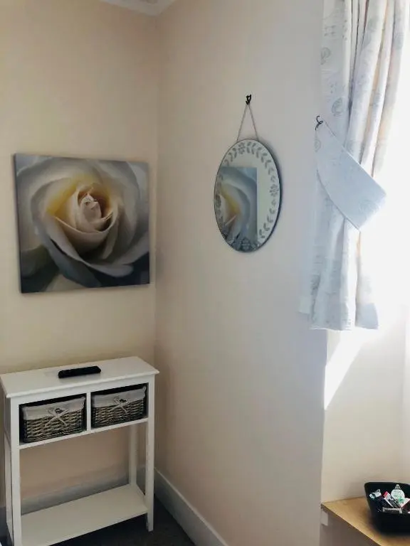 a room with two paintings and a mirror on the wall at The Aberdeen Arms Hotel in Tarves