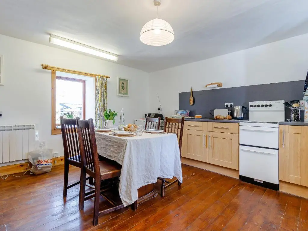 a kitchen with a table and chairs in a room at 19 South Street in Grantown on Spey