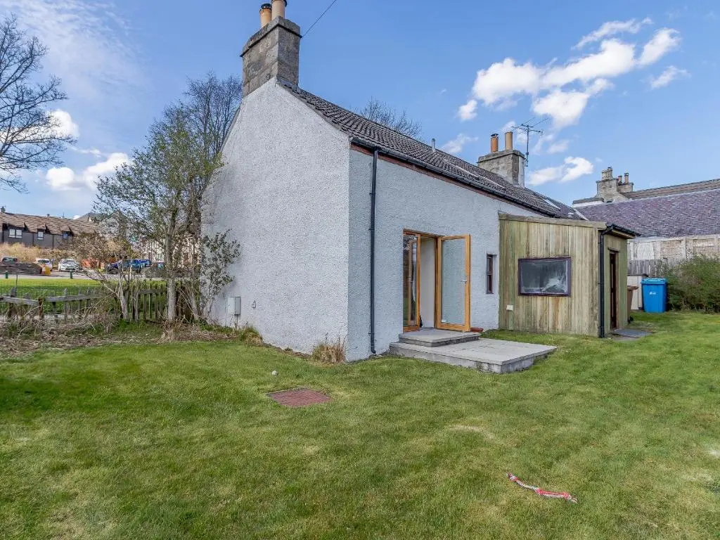 a small white house with a grass yard at 19 South Street in Grantown on Spey