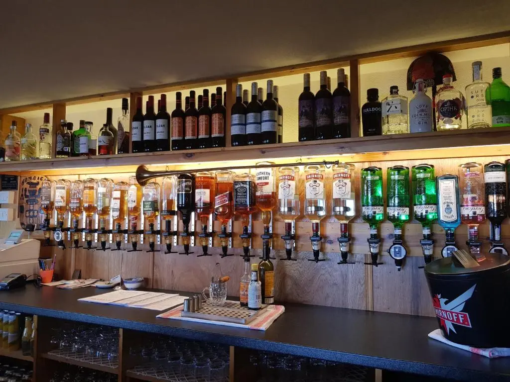 a bar with lots of bottles of alcohol on the wall at Balintore Inn in Balintore