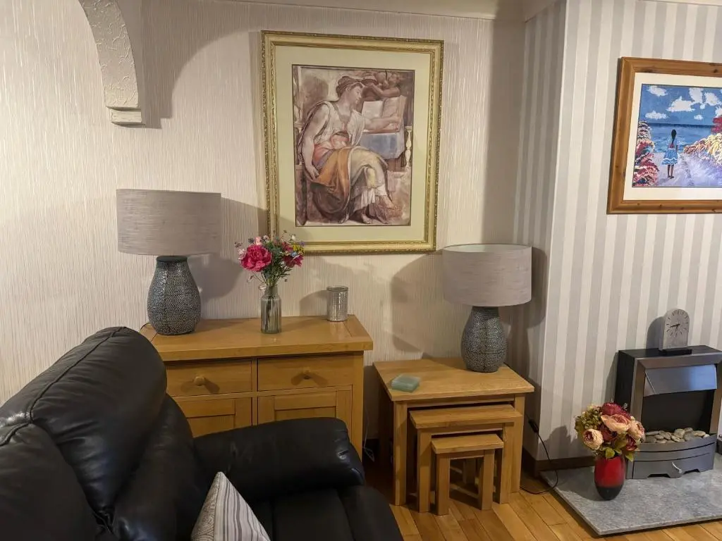 a living room with a couch and a table with two lamps at 3Bed House - Family Friendly - Close To LochNess in Inverness