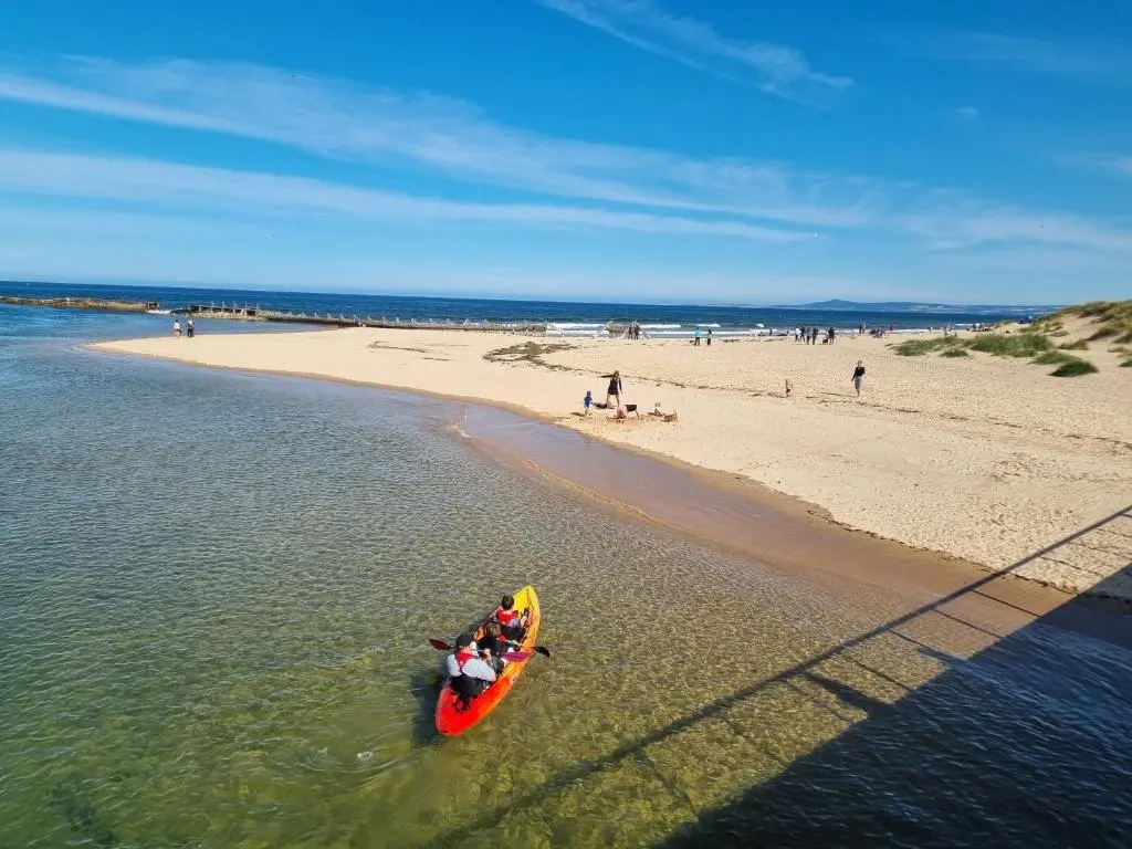 a group of people in a kayak on a beach at The Coal Office Aberlour in Aberlour