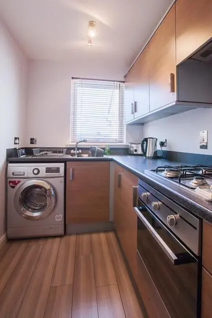 a kitchen with a washing machine and a sink at 2 Bed Blackburn Village Apt With Wifi & Parking in Aberdeen