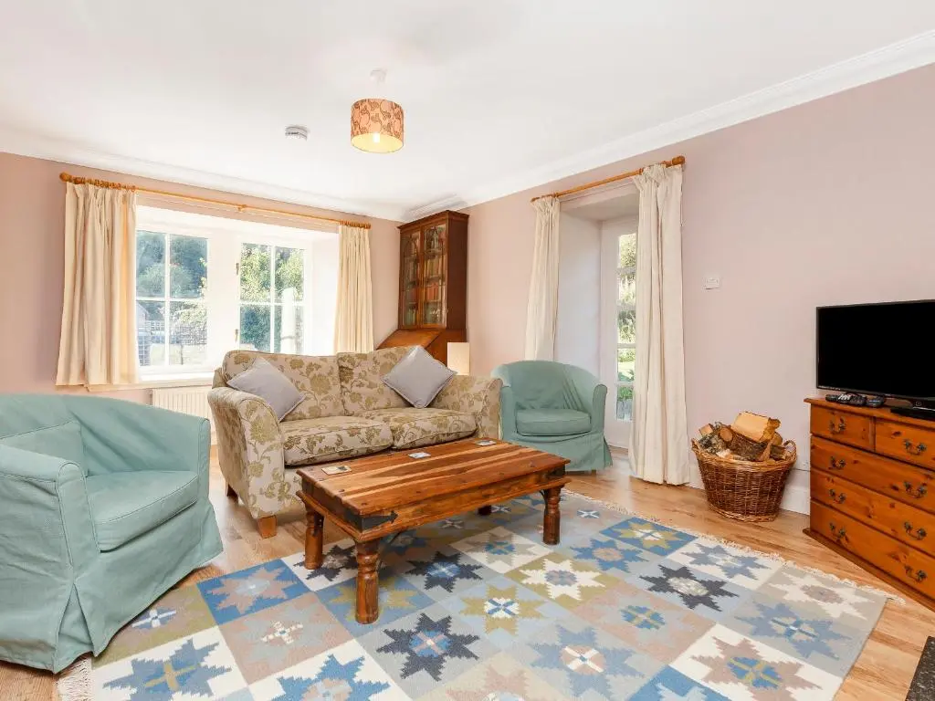 a living room with a couch and a coffee table at Rowan House in Inveran