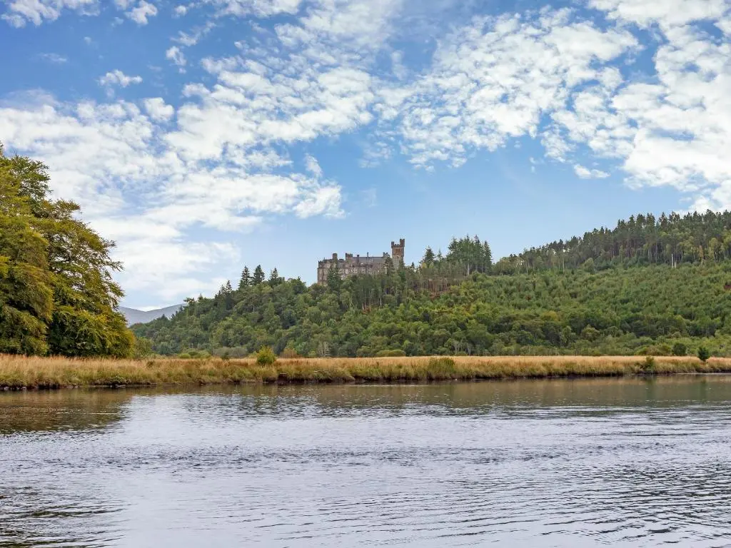 a view of a river with a castle in the background at Rowan House in Inveran