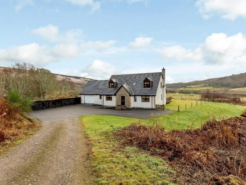 a white house on a hill with a driveway at The Big Hoose in Achnahanat