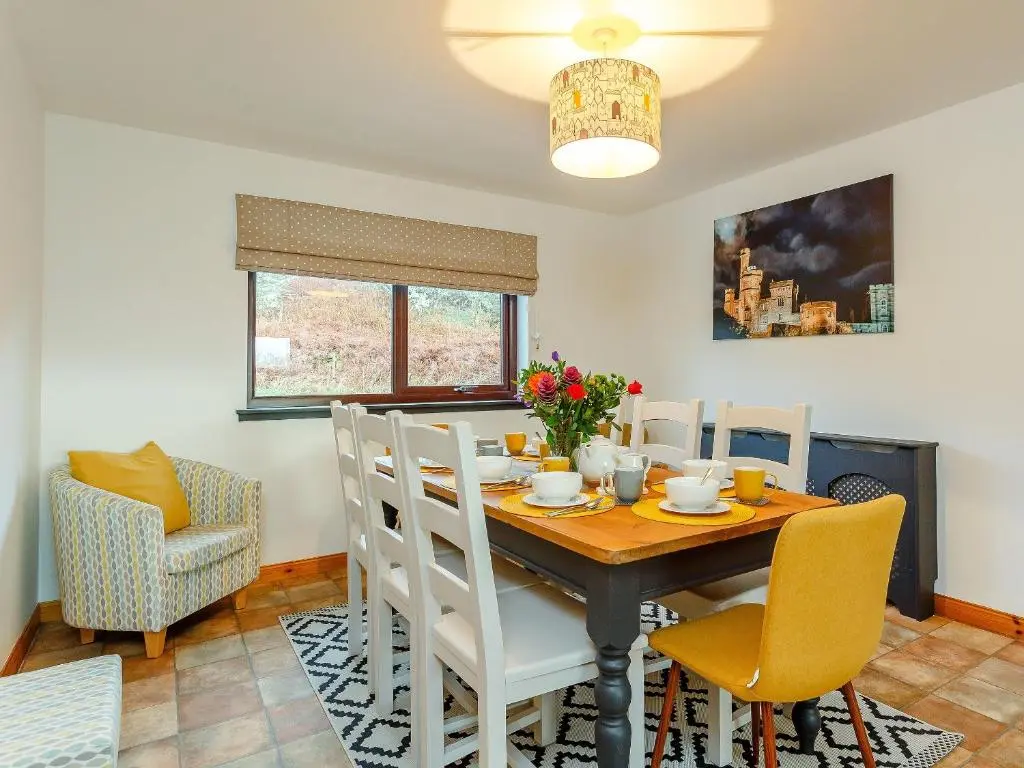 a dining room with a table and chairs at The Big Hoose in Achnahanat