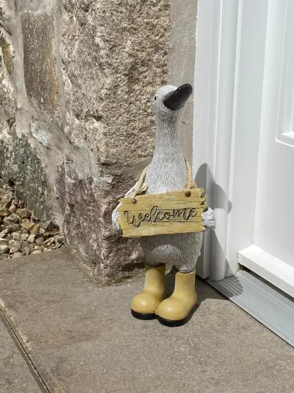 a toy animal wearing a sign on a door at The Den in Stuartfield