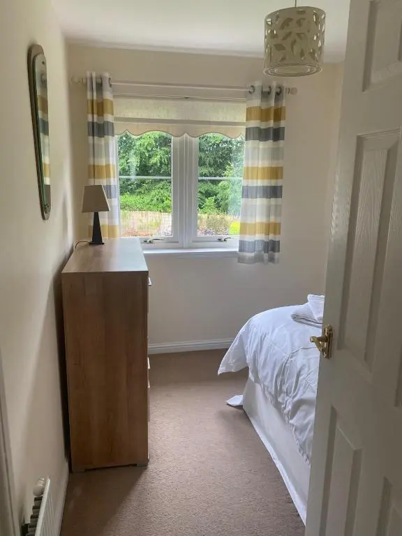 a bedroom with a bed and a window at Kingseat 3 Bed Home With Fast Fibre WiFi &Parking in Newmachar