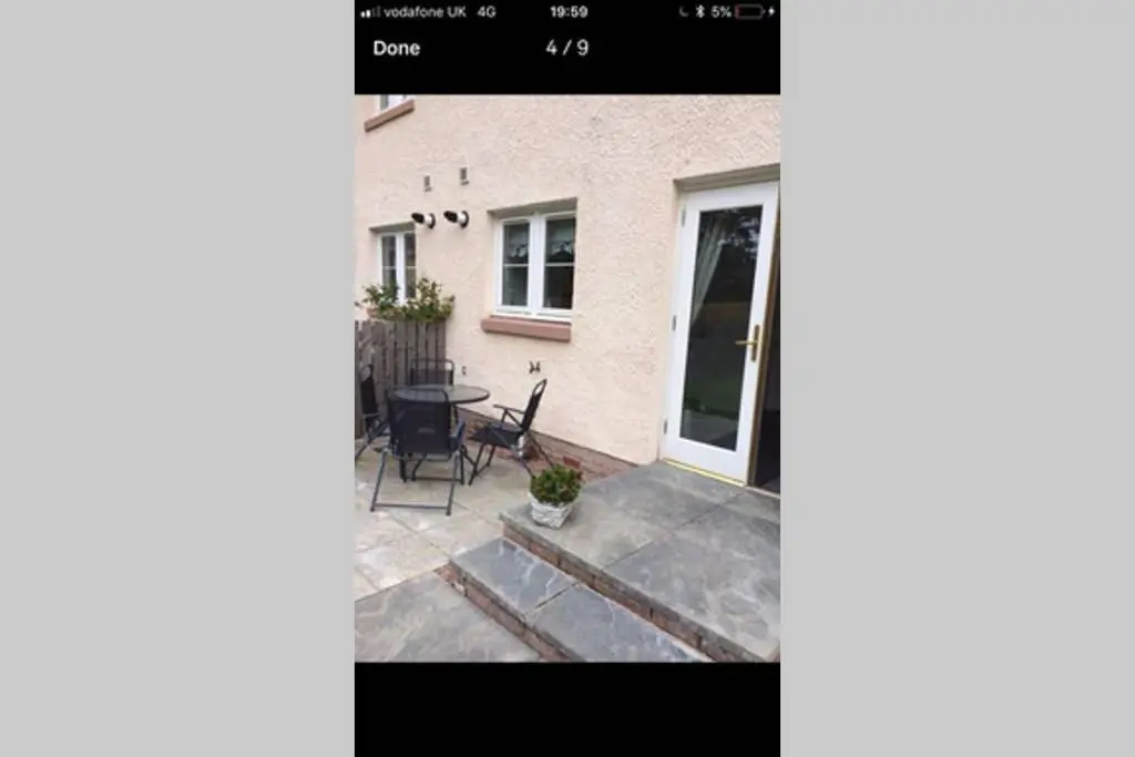 a view of a patio with a table and chairs at Kingseat 3 Bed Home With Fast Fibre WiFi &Parking in Newmachar