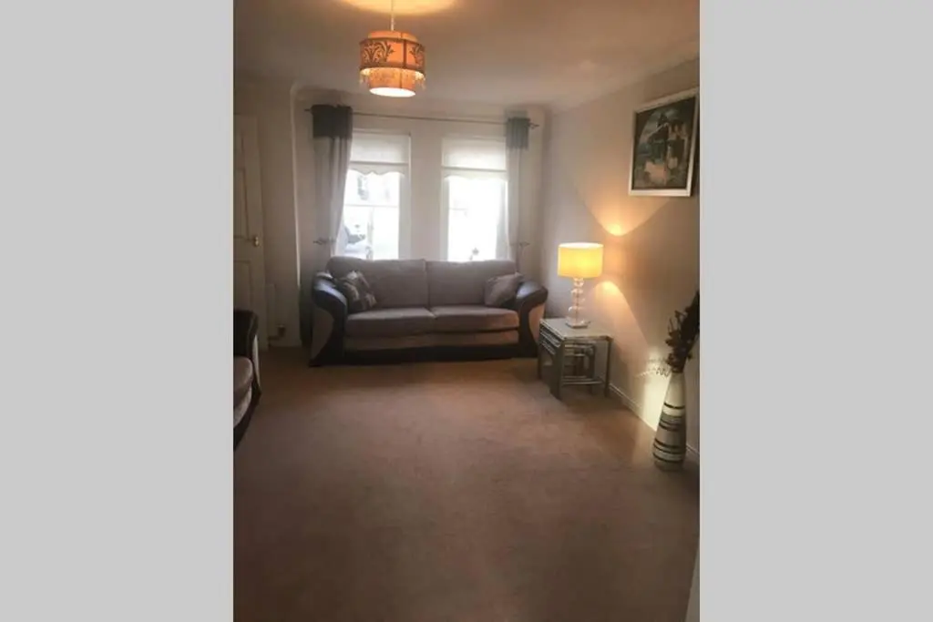 a living room with a couch and a window at Kingseat 3 Bed Home With Fast Fibre WiFi &Parking in Newmachar