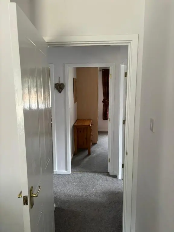 an open door to a hallway with a room at Cairngorm Cottage in Aviemore