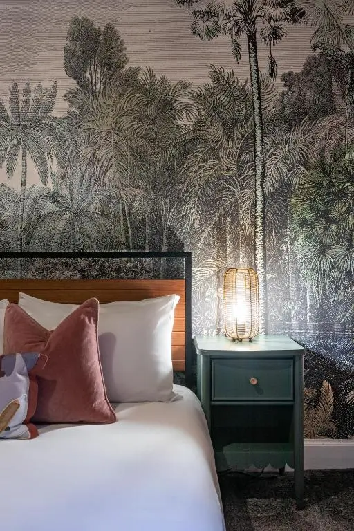 a bedroom with a bed and a nightstand with a lamp at Ness Central in Inverness