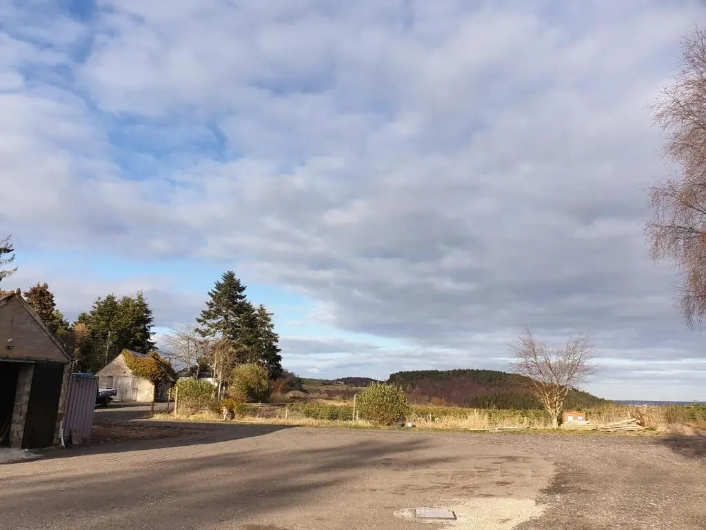 an empty road with a cloudy sky in the background at Craigbreck Farm Cottage in North Kessock