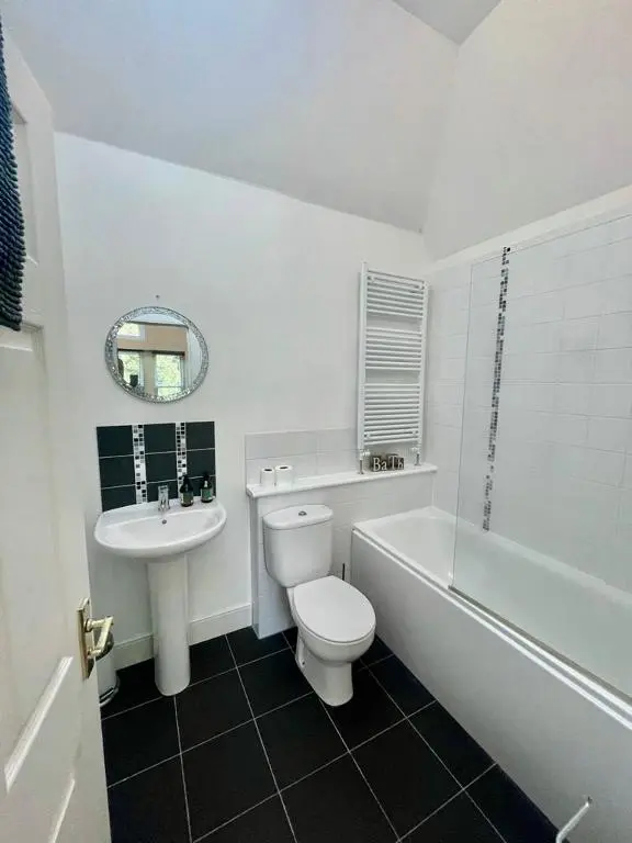a white bathroom with a toilet and a sink at Serviced Accommodation Moray Lesmurdie House, Elgin - Free Parking, Free WiFi in Elgin