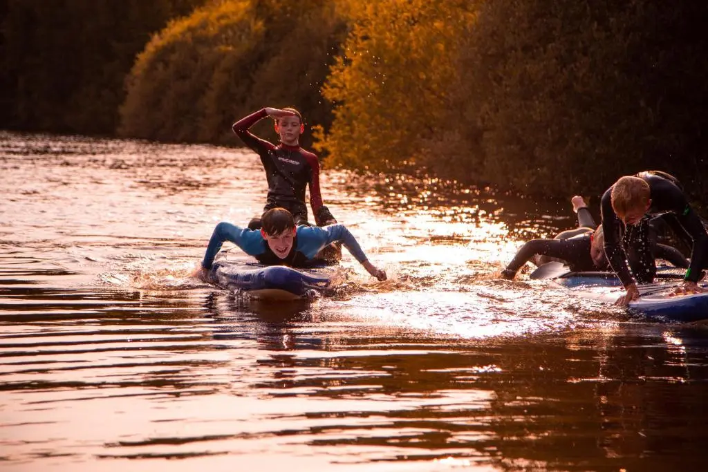 a group of people on surfboards in the water at Balnagown Estates Gardener's Cottage in Kildary