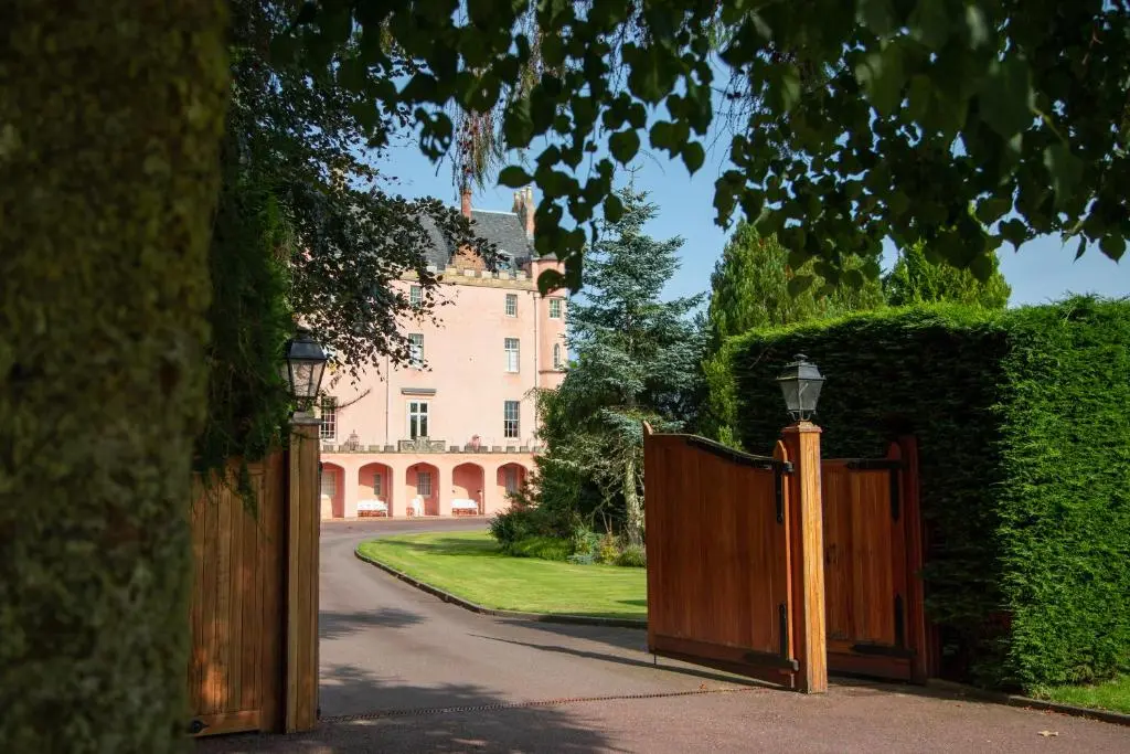 an entrance to a house with a wooden gate at Balnagown Estates Gardener's Cottage in Kildary
