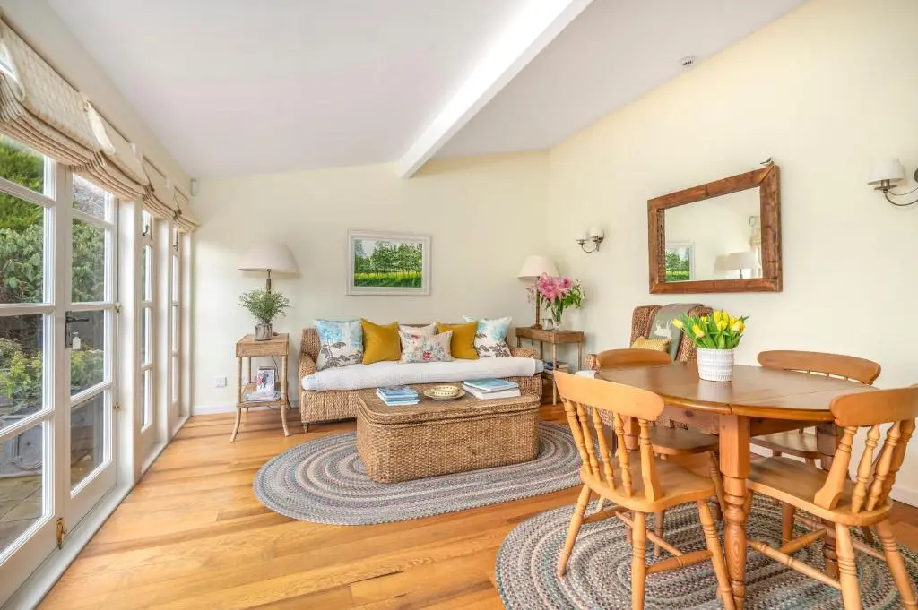 a living room with a table and a couch at Balnagown Estates Gardener's Cottage in Kildary