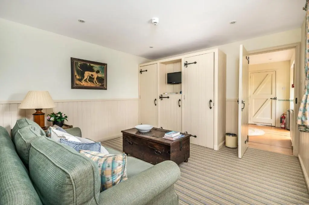 a living room with a couch and a table at Balnagown Estates Gardener's Cottage in Kildary