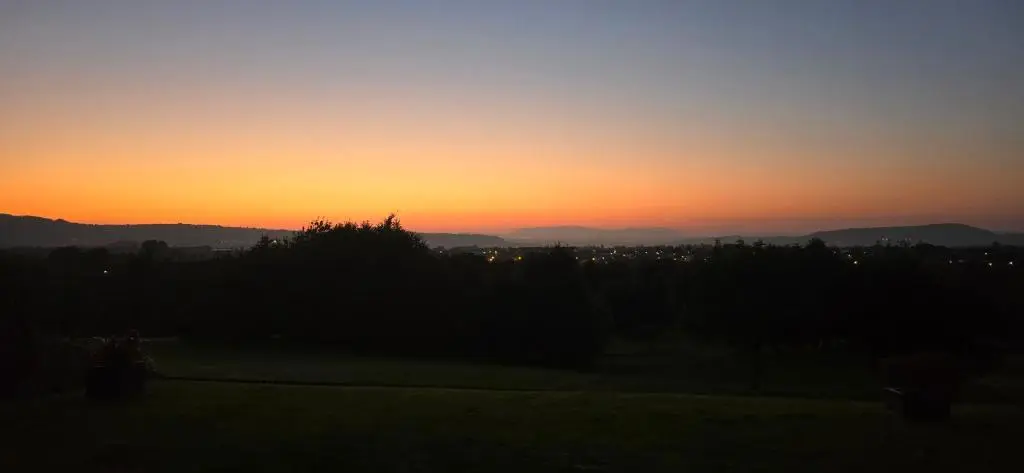 a sunset with a view of a city at Brohar Annexe in Inverness