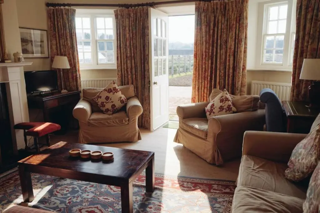 a living room with two couches and a coffee table at Garden Cottage, Fochabers in Fochabers