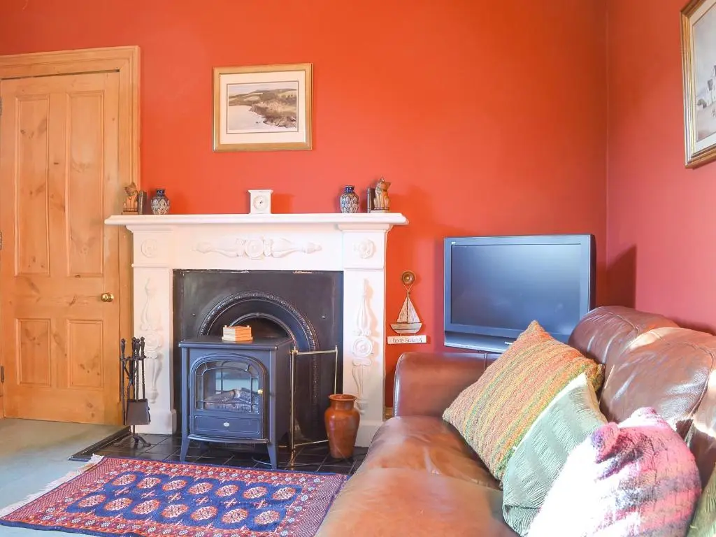 a living room with a couch and a fireplace at Brighton House in Nairn