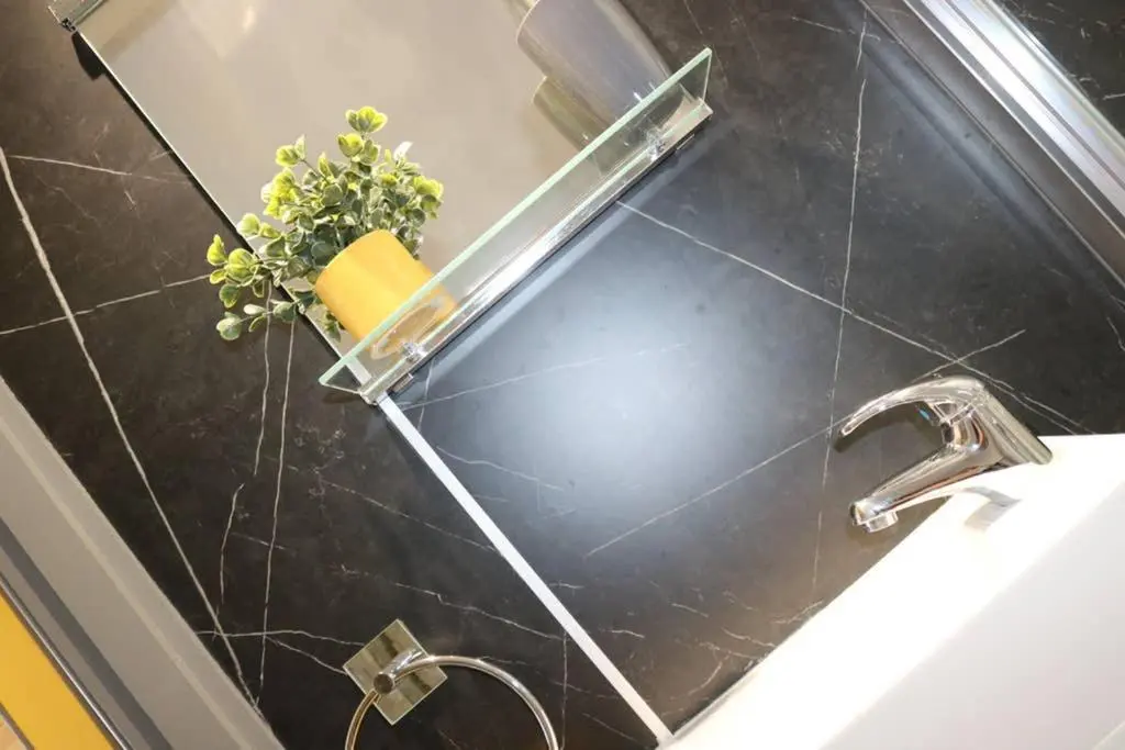 a bathroom sink with a faucet and a plant at Glampods Glamping Pod - meet Highland Cows and Sheep Elgin in Elgin