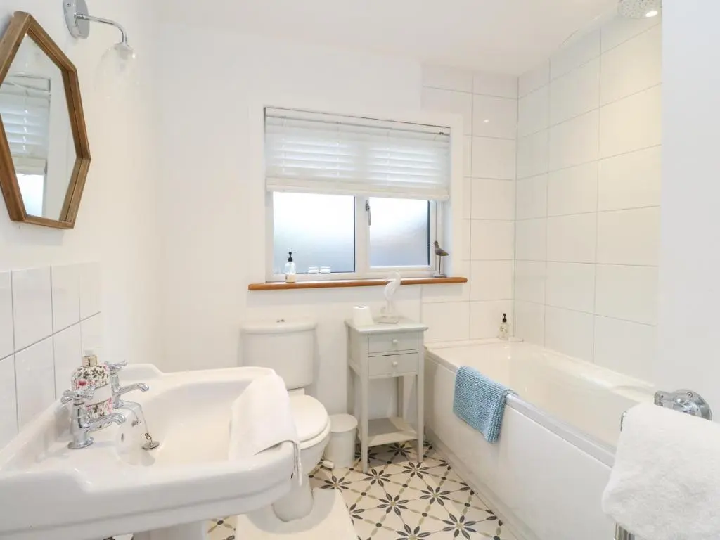a bathroom with a tub and a toilet and a sink at Beechwood Cottage in Pitlochry