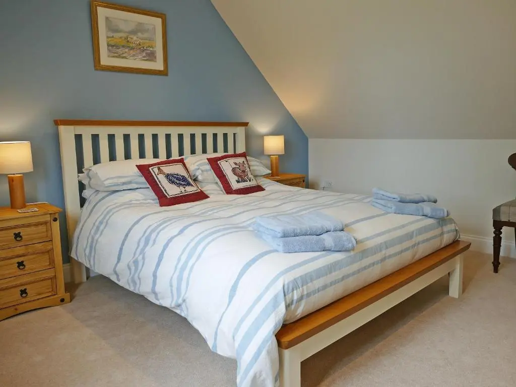 a bedroom with a bed with two pillows on it at Easter Lettoch in Advie