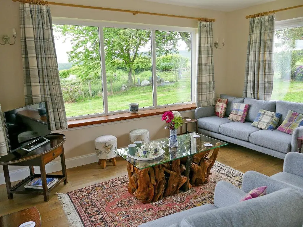 a living room with a tree stump coffee table at Easter Lettoch in Advie