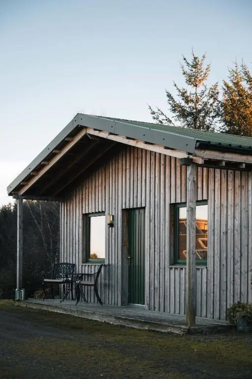 a small house with a bench and a table at The Bothy at Coneloch in Elgin