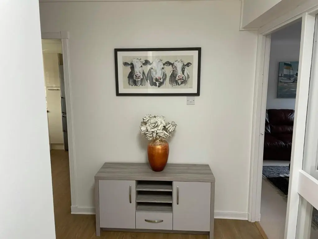 a vase of flowers on a table in a room at Lesmurdie Court, Serviced Accommodation Moray in Elgin