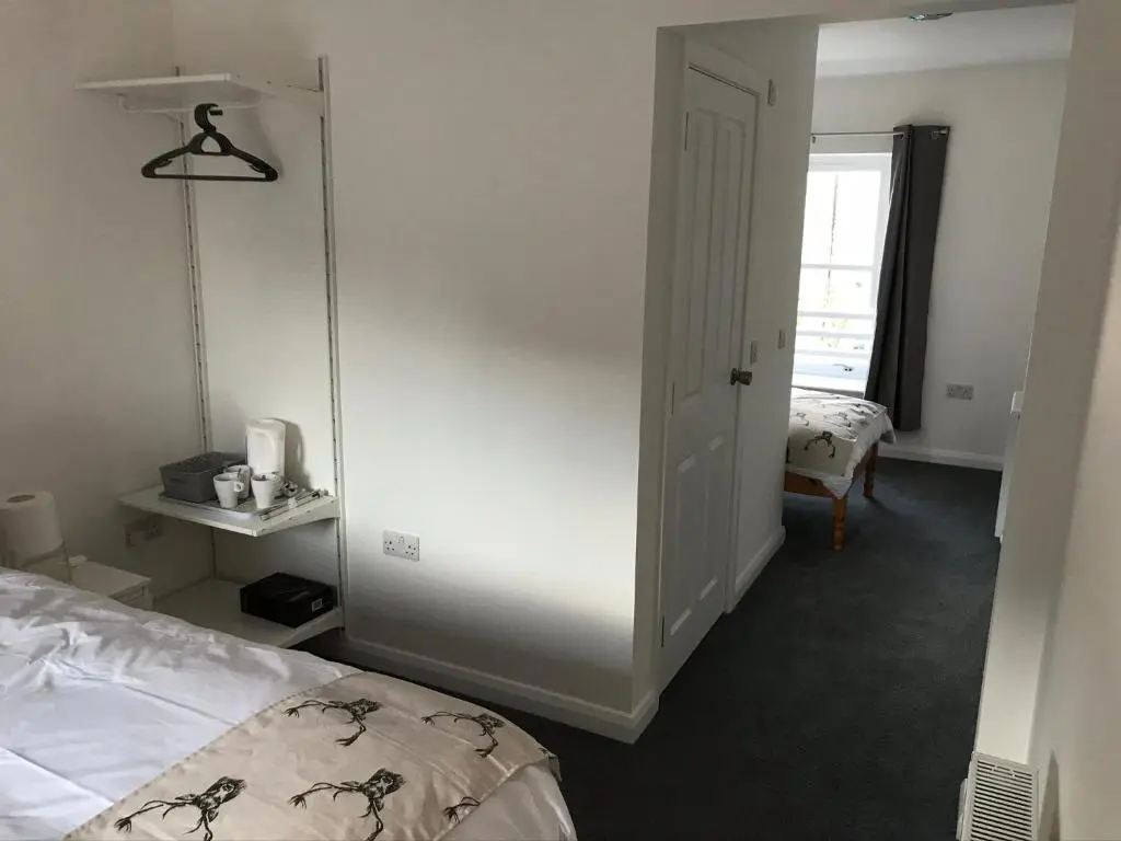 a room with a bed and a door to a bedroom at Thistle House in Inverness