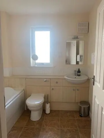 a bathroom with a toilet and a sink at Tieveragh in Aviemore