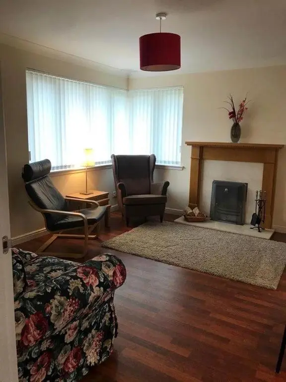 a living room with a couch and a fireplace at Tieveragh in Aviemore