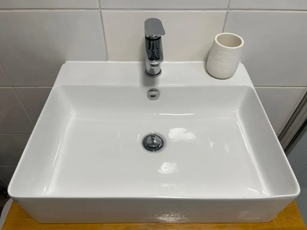 a white sink with a faucet on top of it at Balnakyle in Inverness