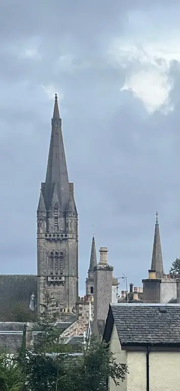 an old building with a clock tower in the background at Balnakyle in Inverness