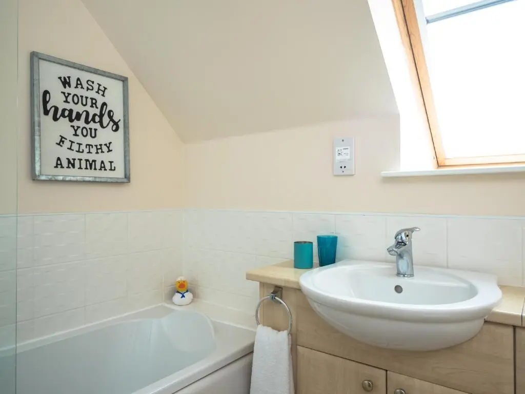 a bathroom with a sink and a bath tub at Eagle Lodge - Aviemore Lodges in Aviemore