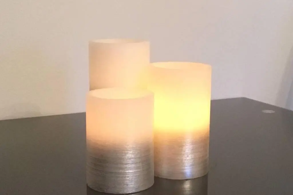 three white candles sitting on top of a table at The Annex at Bonnieview in Inverness