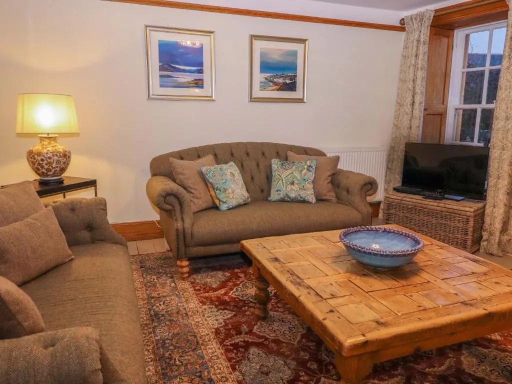 a living room with a couch and a coffee table at Paye House - Cromarty in Cromarty