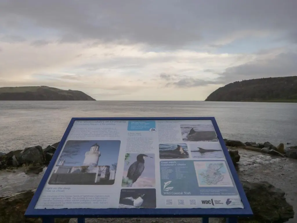 a sign in front of a body of water at Lydia Cottage - Cromarty in Cromarty