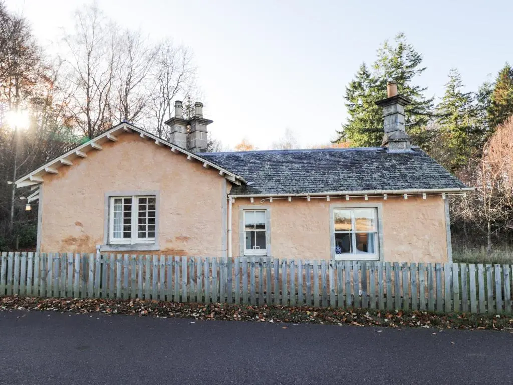 a small house with a fence in front of it at Cormack Lodge - Brodie Castle in Forres