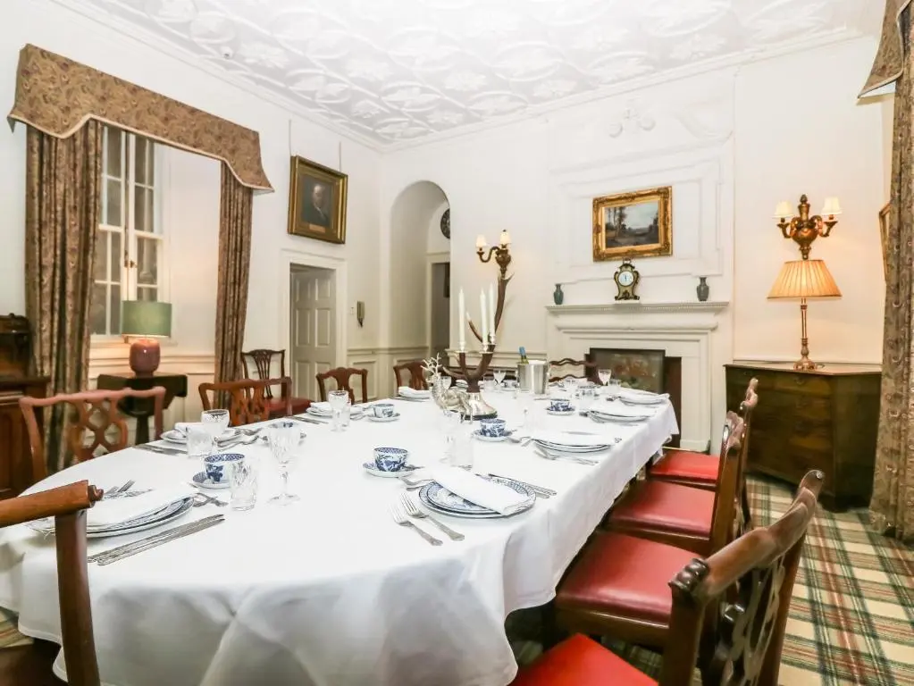 a dining room with a long table and chairs at The Preston Tower Apartment - Fyvie Castle in Turriff