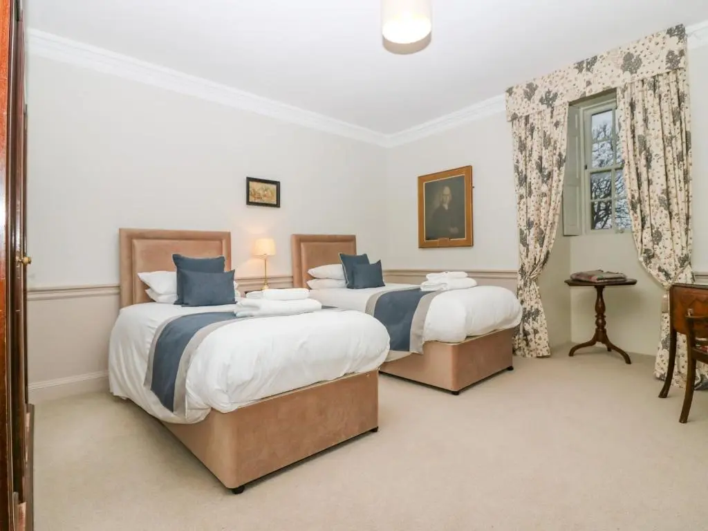 a bedroom with two beds and a window at The Preston Tower Apartment - Fyvie Castle in Turriff