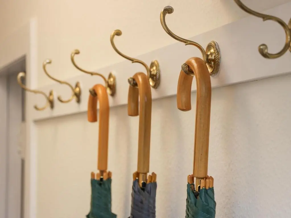 a group of umbrellas hanging on a wall at Beechgrove Cottage - Pitmedden Gardens in Ellon