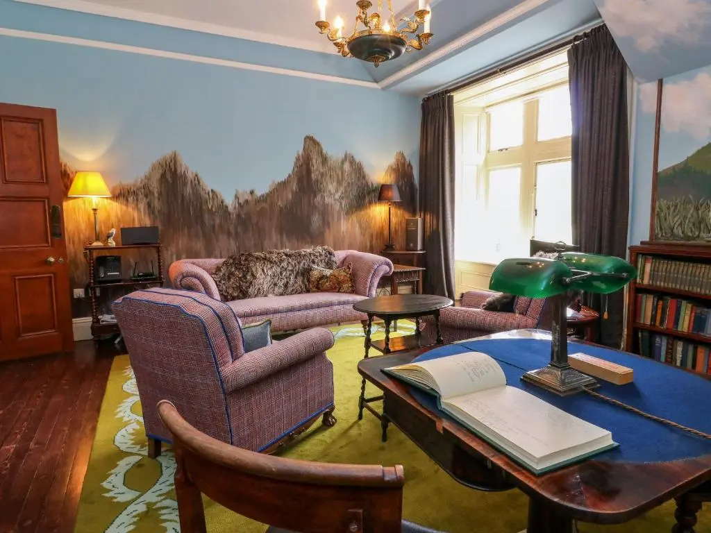 a living room with a couch and a table at Dalvorar - Mar Lodge Estate in Ballater