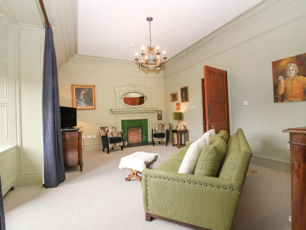 a living room with a couch and a fireplace at Macdui - Mar Lodge Estate in Ballater
