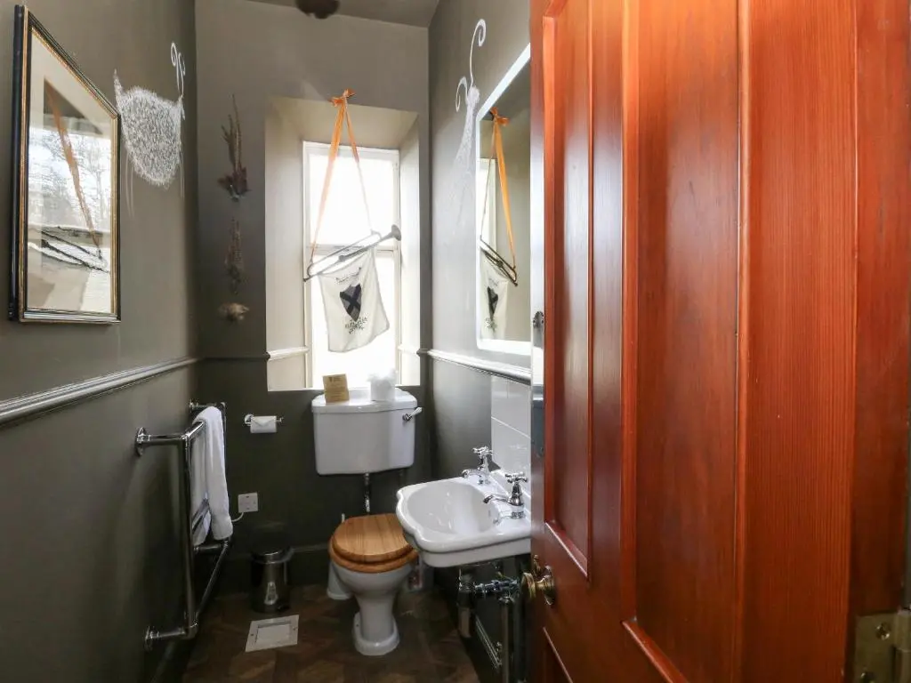 a bathroom with a sink and a toilet and a window at Derry - Mar Lodge Estate in Ballater