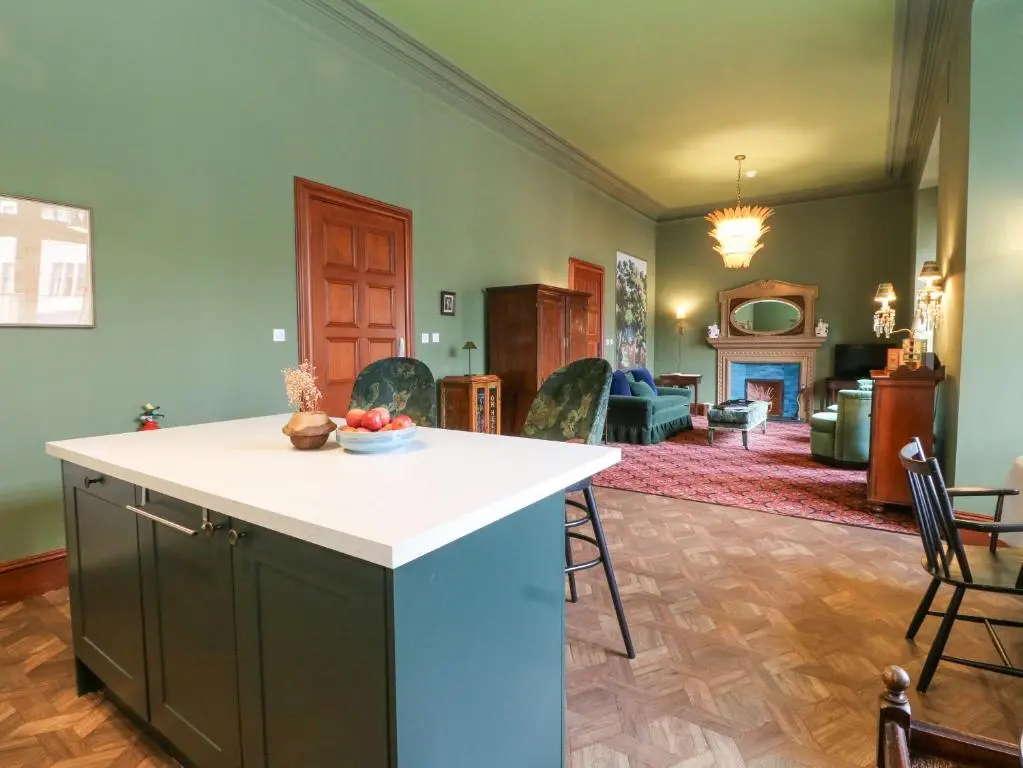 a kitchen and living room with a table and chairs at Derry - Mar Lodge Estate in Ballater