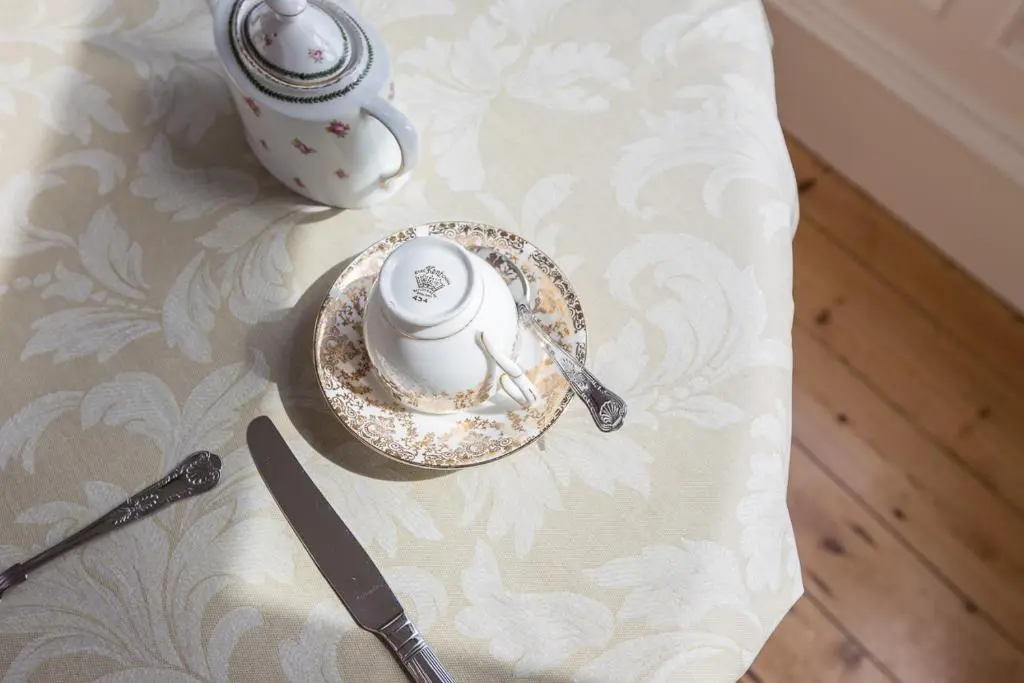 a table with two cups and a plate and a knife at Chrialdon House in Beauly